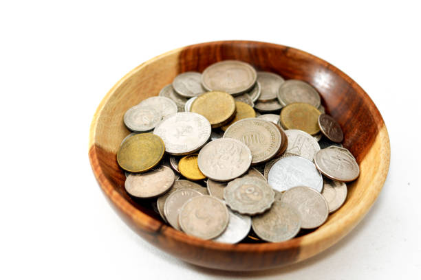 istock collection of different coins from multiple countries around the world background in a brown wooden bowl isolated on a white background 1354202681