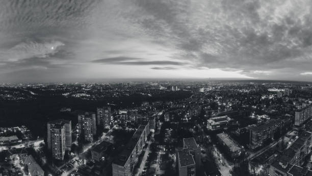 istock Aerial grayscale view, evening city streets pano 1354203044