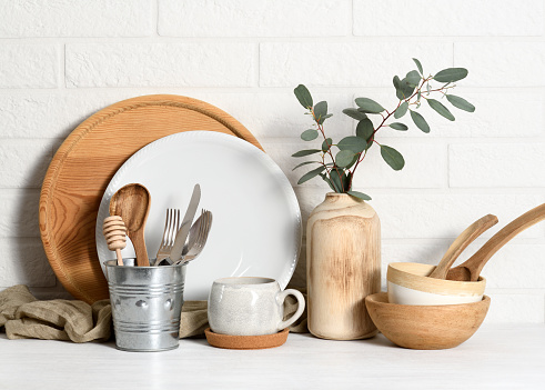 Arrangement of tableware against a white brick wall