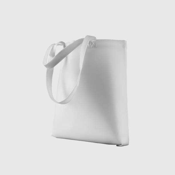 istock Mock up of white totebag 3d rendering, reusable ecobag with handle, for shopping, isolated on background. 1354204803