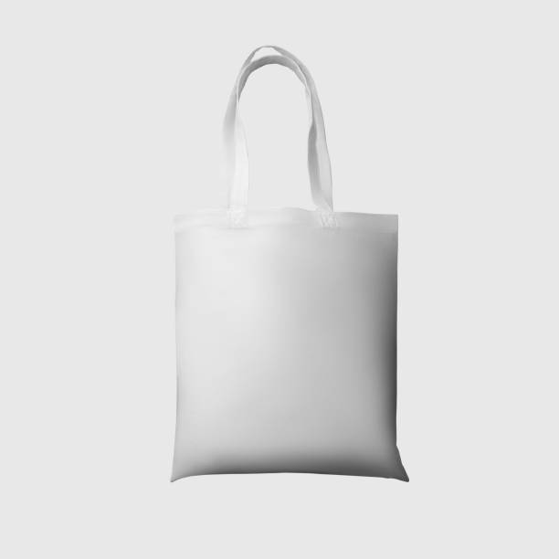 istock Mock up of white totebag 3d rendering, reusable ecobag with handle, for shopping, isolated on background. 1354204845