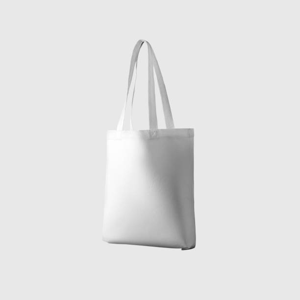 istock Mock up of white totebag 3d rendering, reusable ecobag with handle, for shopping, isolated on background. 1354204884