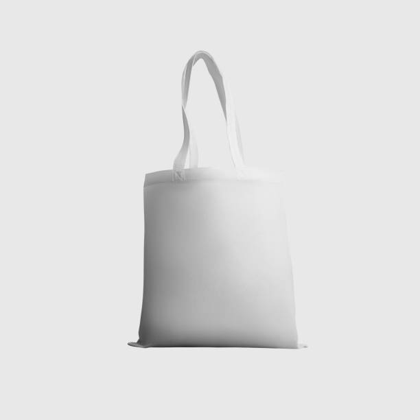 istock Mock up of white totebag 3d rendering, reusable ecobag with handle, for shopping, isolated on background. 1354204891