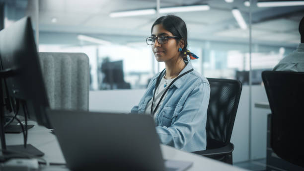 diverse office: portrait of talented indian girl it programmer working on desktop computer in friendly multi-ethnic environment. female software engineer wearing glasses develop inspirational app - computer programmer designer computer computer language imagens e fotografias de stock