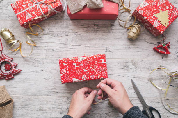 istock Men wrapping Christmas gifts 1354206503