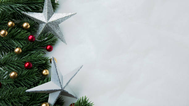 istock Christmas decorations, pine tree leaves, balls, berries on snow white background, Christmas concept 1354208277