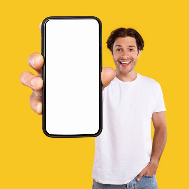 istock Man showing white empty smartphone screen close to camera 1354208296