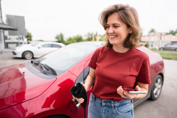 istock Woman with smartphone and charging plug 1354209369