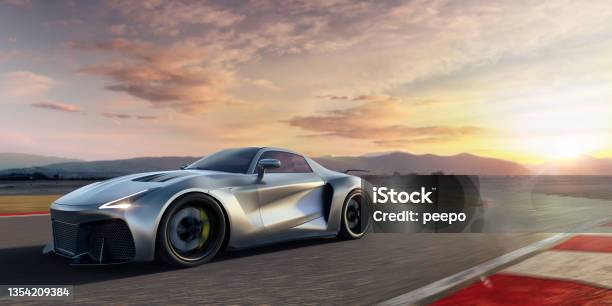 Silver Roadster Sports Car Moving At High Speed Along Racetrack At Dawn Stock Photo - Download Image Now