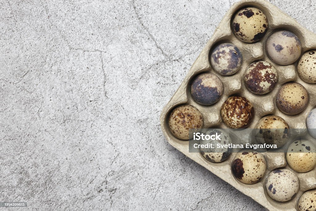 Food background of quail eggs close-up containing vitamin A, B, PP, B12, amino acids, beta-carotene, calcium, magnesium, iron, phosphorus, protein, choline, riboflavin, folic acid, selenium. Above Stock Photo