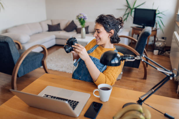 istock Young photographer watching her photos on a camera and having fun 1354212130