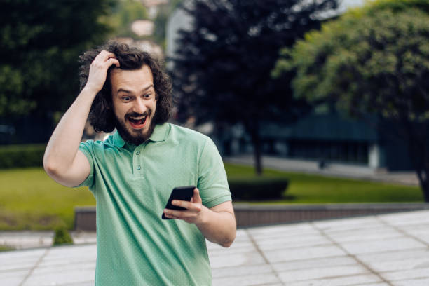 istock Portrait of a young man using a mobile app outdoors 1354212172