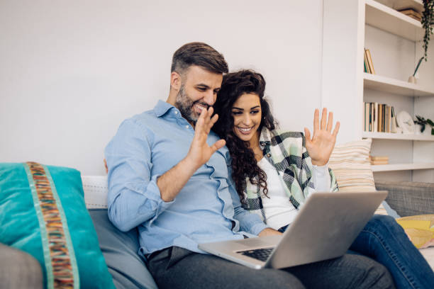 istock Couple relaxing on the sofa and surfing the net 1354212407