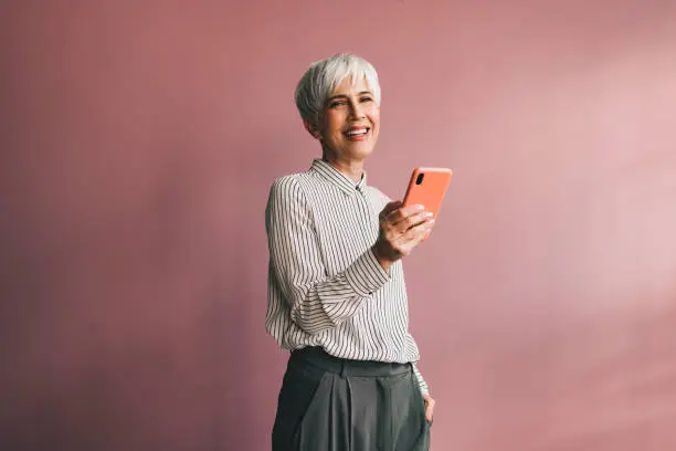 Photo of Portrait of a Senior Business Woman Using Mobile Phone