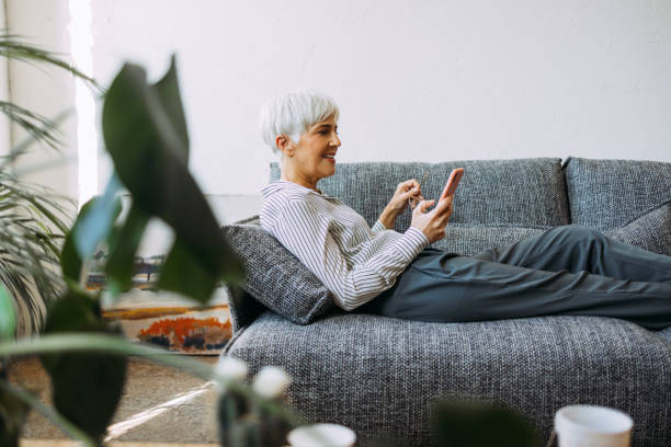 istock Senior Woman Using Mobile Phone at Home 1354214205