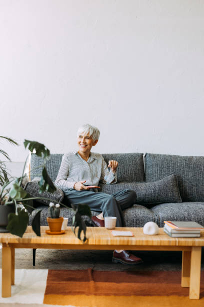 istock Senior Woman Using Mobile Phone at Home 1354214206
