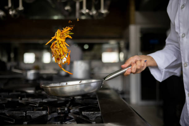 istock Close-up on a chef sauteing vegetables in a pan 1354214268