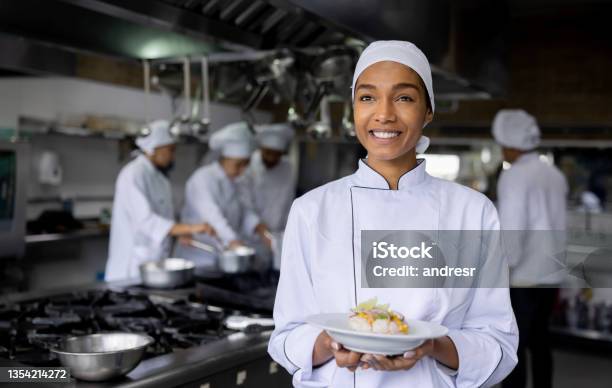 Happy Cook Preparing Food At A Restaurant And Presenting A Plate Stock Photo - Download Image Now