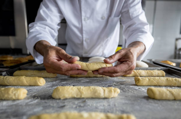istock Close-up on a baker making cheese rolls at a pastry shop 1354214309