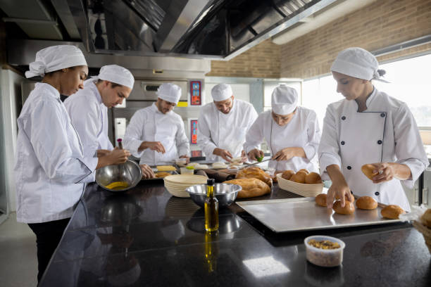 istock Group of bakers making break at the bakery 1354214317