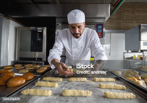 istock Baker baking pastries at a pastry shop 1354214320