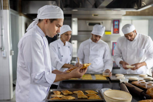 istock Group of bakers working at the bakery 1354214331