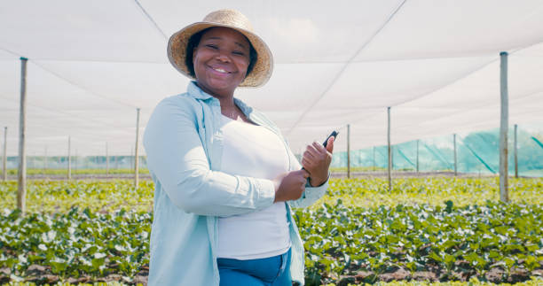 istock Portrait of a young woman using a digital tablet while working on a farm 1354215277
