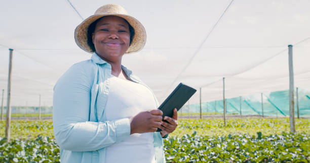 istock Portrait of a young woman using a digital tablet while working on a farm 1354215281