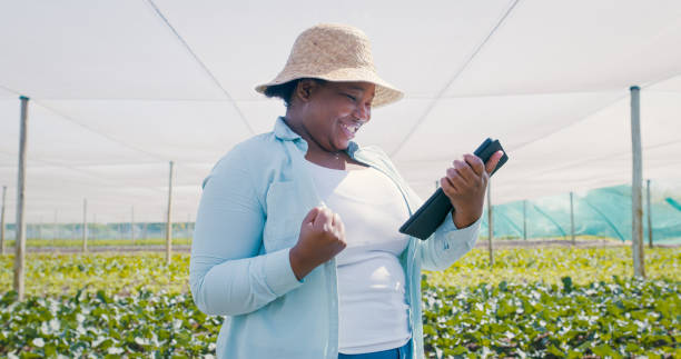 istock Shot of a young woman using a digital tablet and cheering while working on a farm 1354215282