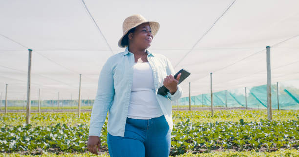 Shot of a young woman using a digital tablet while working on a farm