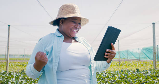 istock Shot of a young woman using a digital tablet and cheering while working on a farm 1354215314