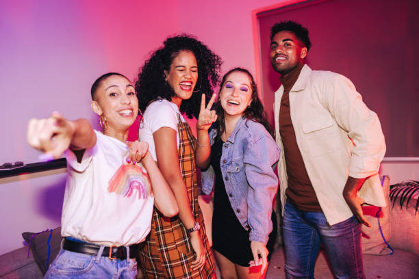 istock Four happy friends having a good time at a party 1354216990