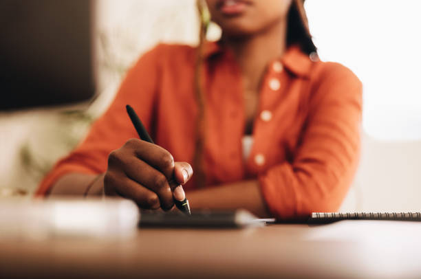 Female graphic designer drawing with a stylus pen