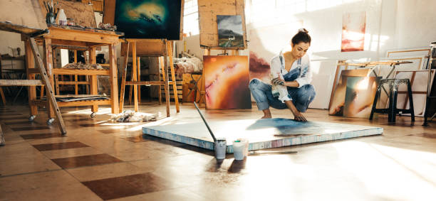 istock Artist working on a new painting in her studio 1354220836