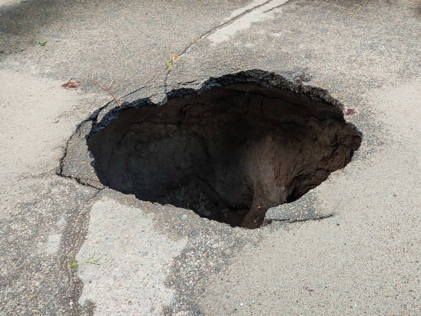 istock Large hole in the asphalt, sinkhole 1354221651