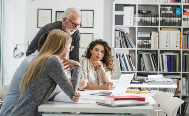 istock Working day in a design studio.Group of designers on meeting.Thay discuss about new project. 1354222807
