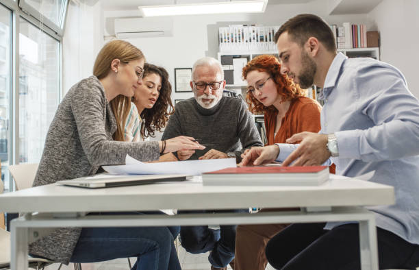 istock Working day in a design studio.Group of designers on meeting.Thay discuss about new project. 1354222833
