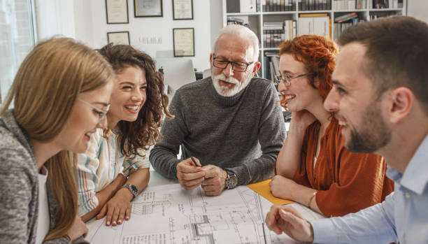 istock Working day in a design studio.Group of designers on meeting.Thay discuss about new project. 1354222839