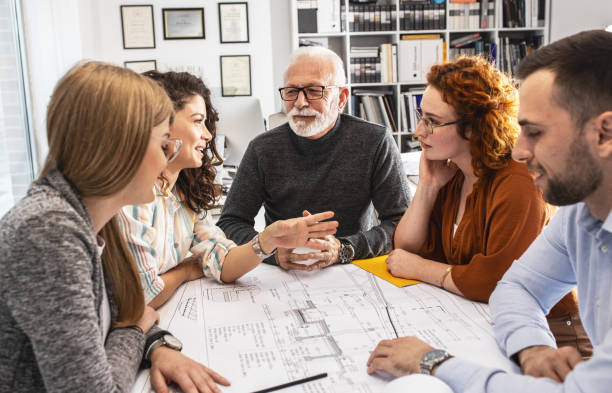 istock Working day in a design studio.Group of designers on meeting.Thay discuss about new project. 1354222848