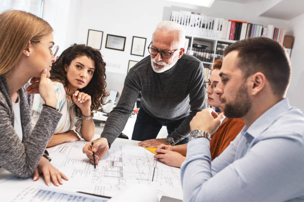 istock Working day in a design studio.Group of designers on meeting.Thay discuss about new project. 1354222851
