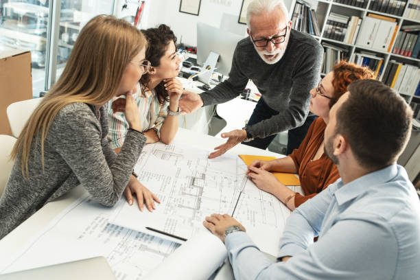 istock Working day in a design studio.Group of designers on meeting.Thay discuss about new project. 1354222861