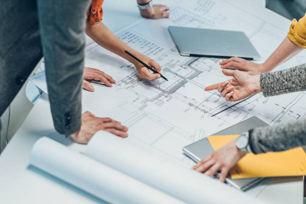 istock Group of architect on meeting.Looking and discuss blueprint.Only hands are visible. 1354223022