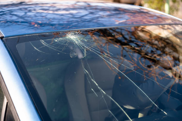 istock Shocked woman in car with broken windshield  and cracks. Car accident. Selective focus 1354225307
