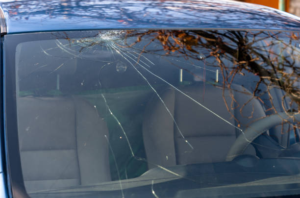 istock Broken windshield of a car with cracks. Car accident. Selective focus 1354225363