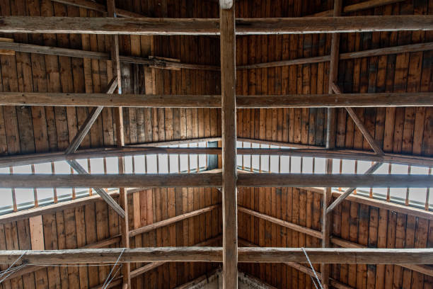 istock Timbers and beams in an old barn. Wooden roof coverage. 1354226091