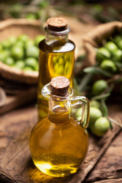 istock Extra virgin olive oil with fresh green olives 1354226148