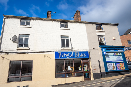 Bengal Blues on Market Place of Belper in Derbyshire, England, with other commercial shops visible