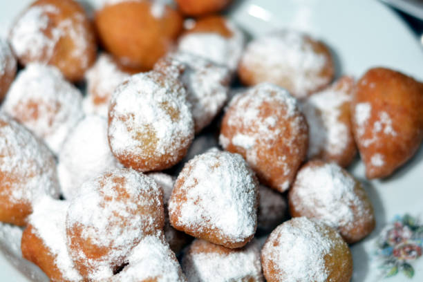 istock Zalabia covered with powdered sugar on a white plate, a type of middle eastern fried dough similar to that of a doughnut 1354227233