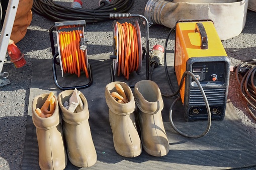 Special dielectric rubber boots and gloves designed to work with high voltage. High voltage protective insulating shoes and gloves.