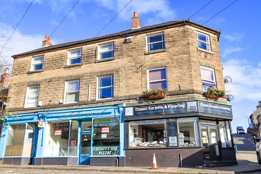 Classic Carpets & Flooring on Belper Market Place in Derbyshire, England, with other shops visible nearby